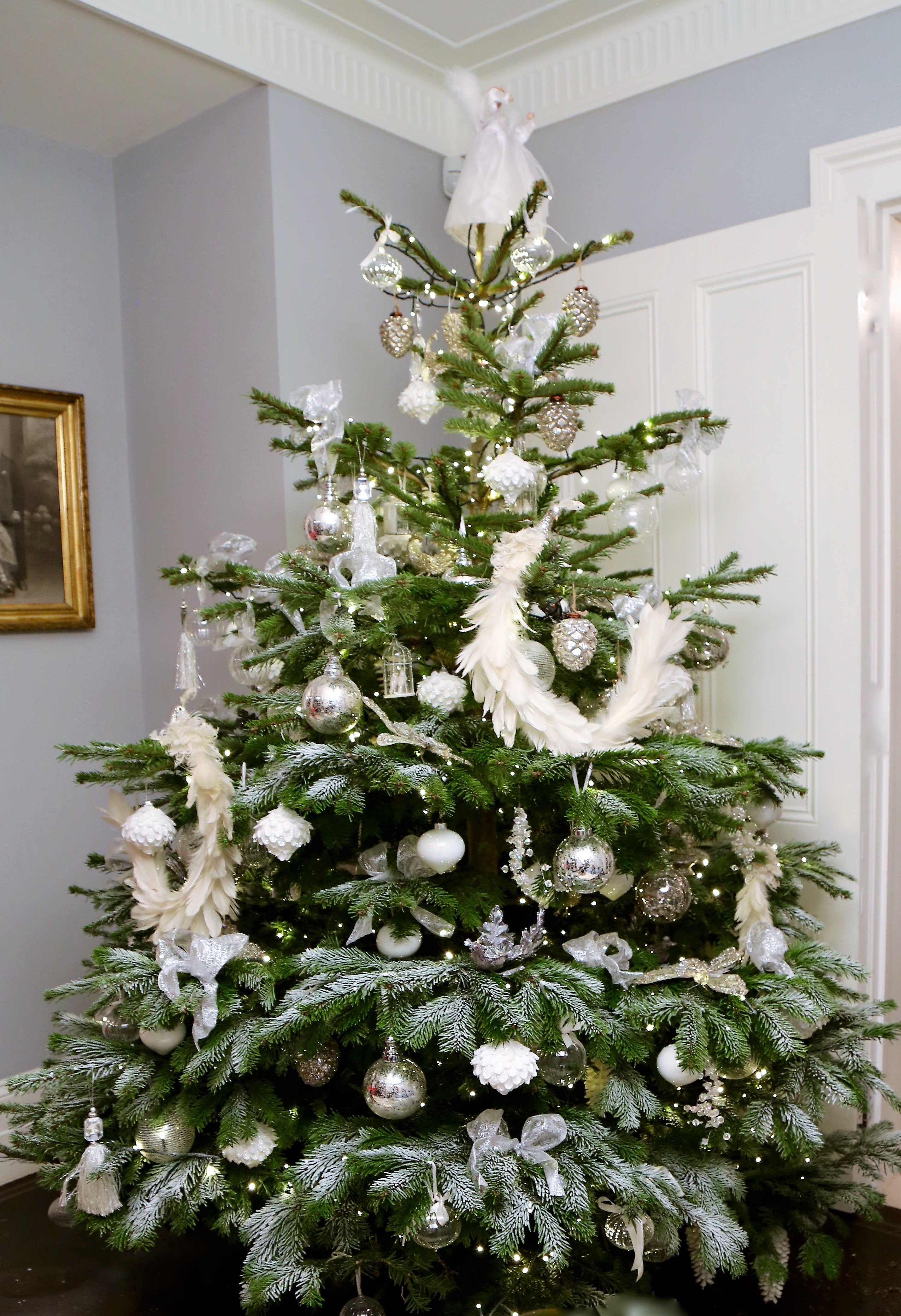 Tall Christmas floral installation with rich seasonal greenery