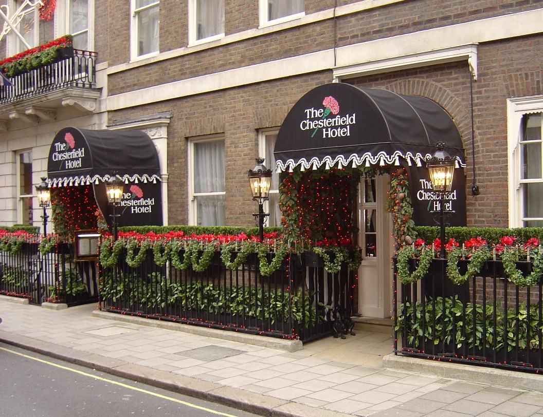 Outdoor floral display and planting beside a building entrance