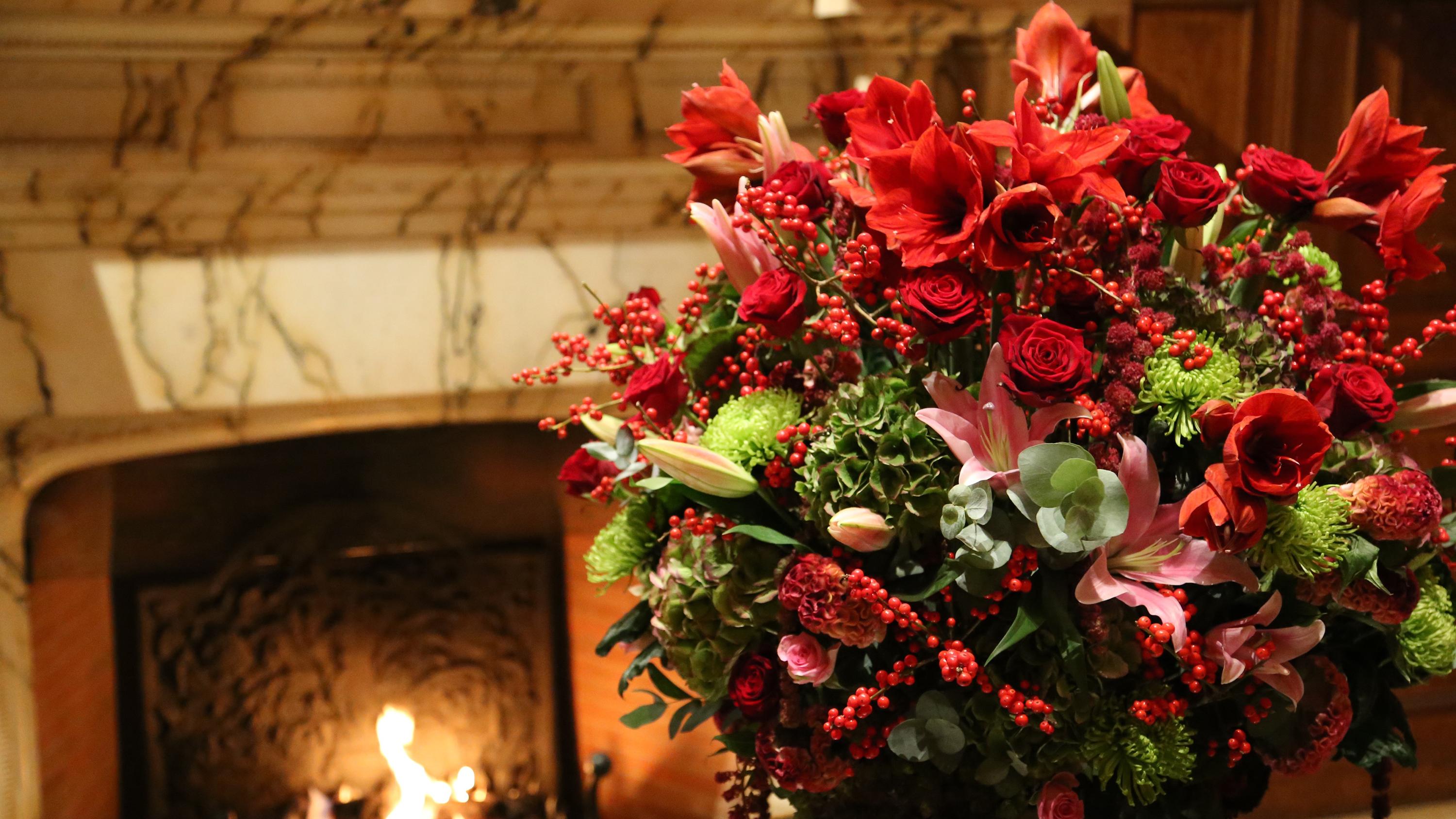 Wide fresh flower display with rich red and green floral texture