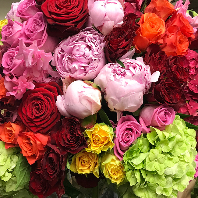 Workshop flowers arranged with roses and seasonal foliage