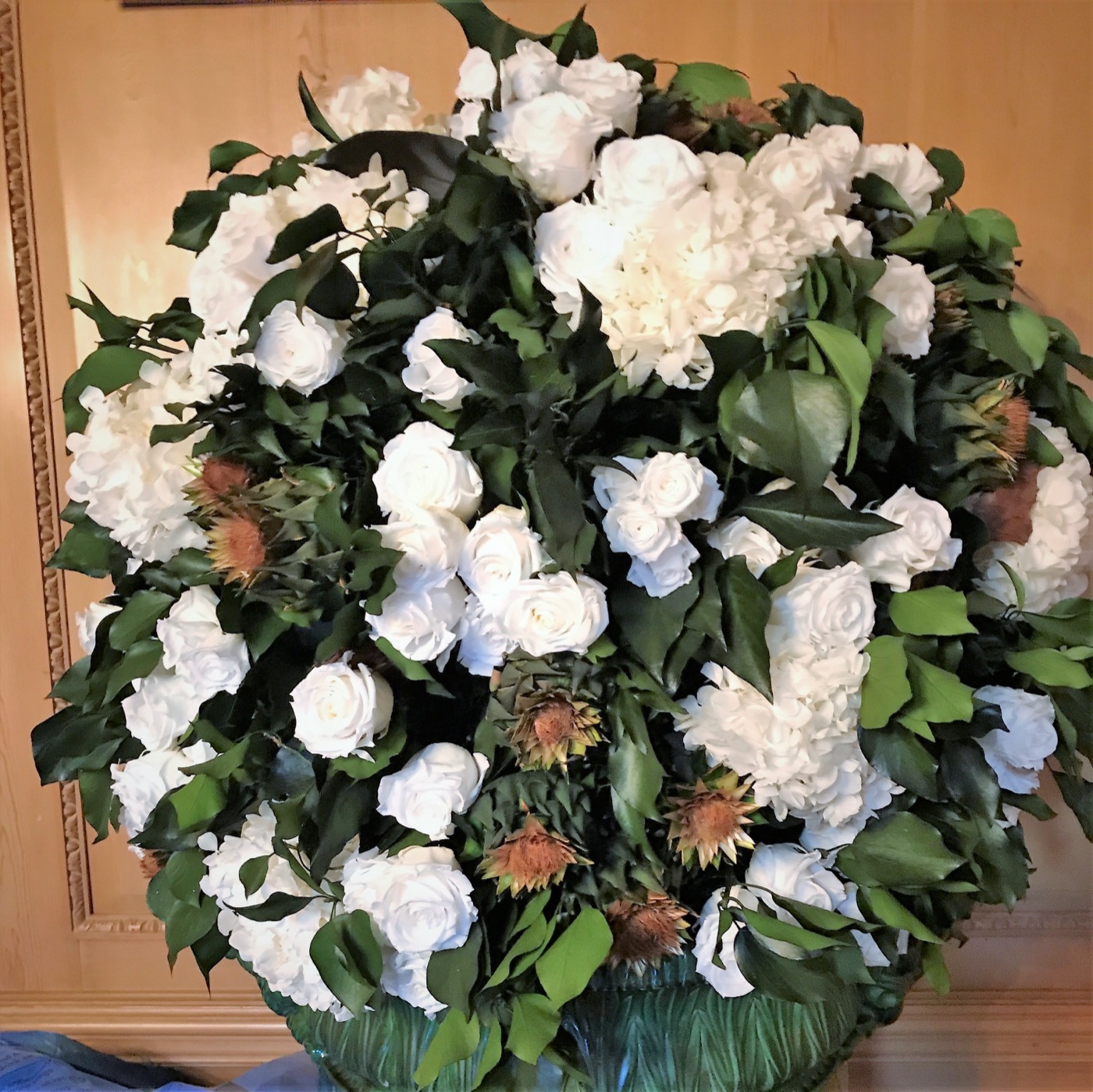 White preserved roses and foliage in a long-lasting arrangement
